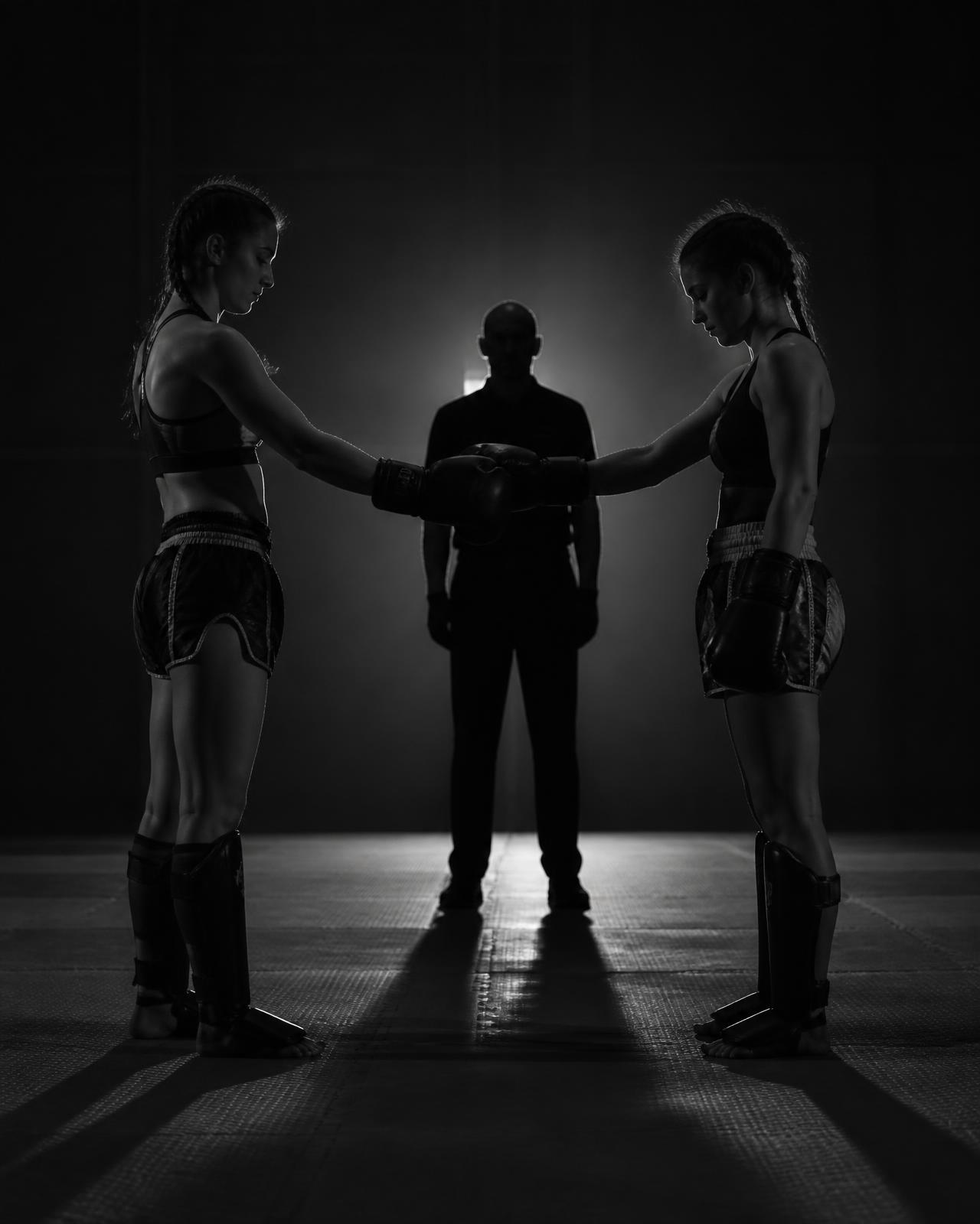Two kickboxers touching gloves before a bout